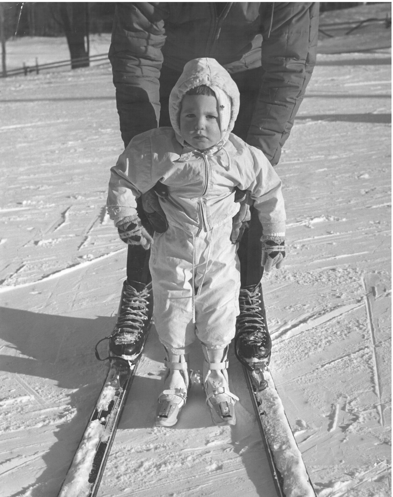 Kathleen Brisebois, 2, of Albany, N.Y., receives skiing lessons from her father, Gaston at Bousquet's in March 1960